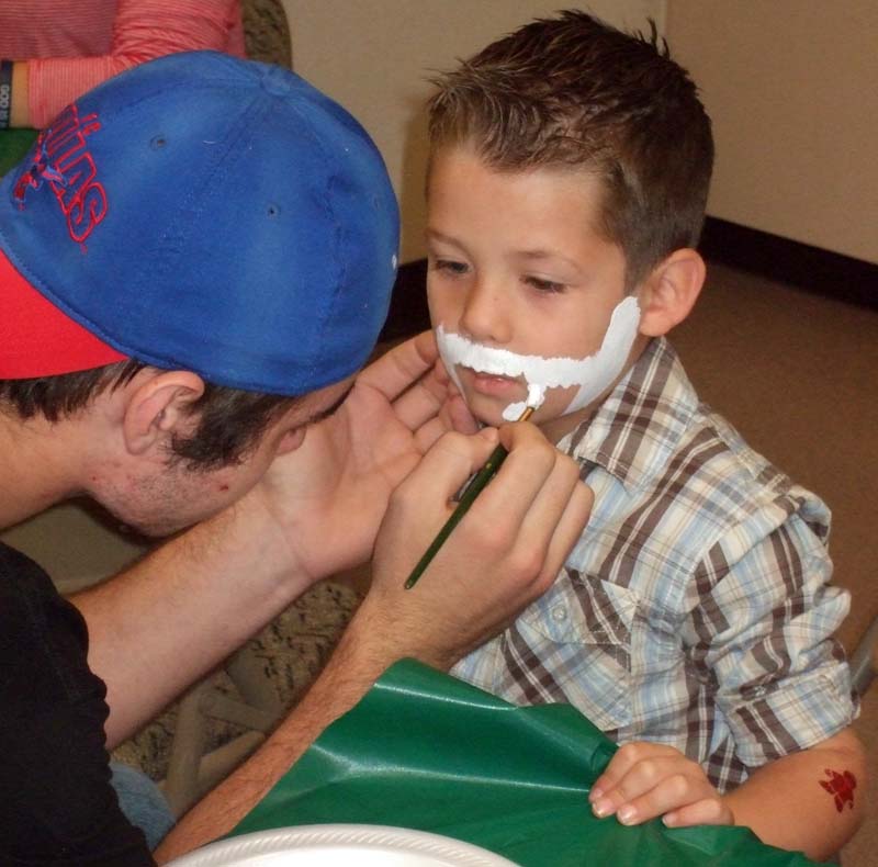 photo of boy getting face painted